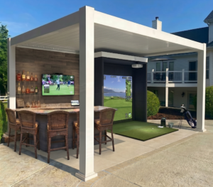 Explore this custom luxury pergola build in Clearwater, FL, featuring a complete outdoor bar, wall-mounted TV, and a professional-grade golf simulator bay with a large screen and projector.