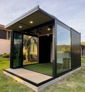 A custom-built, freestanding luxury outdoor golf simulator gazebo installed in a residential backyard in Tampa, Florida, featuring a weather-proof architectural structure, a premium impact screen, and a dedicated hitting area separate from the main house.