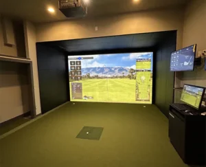 A detailed view of premium, custom-fitted black impact padding lining the interior walls of a luxury residential golf simulator enclosure in Tampa Bay, Florida, engineered to safely absorb errant golf balls, reduce noise, and provide a sleek architectural finish.