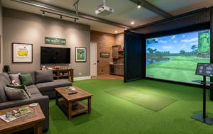 A custom-engineered luxury residential indoor golf simulator sanctuary installation featuring a seamless, flush-mounted synthetic turf flooring that transitions perfectly from the putting mat to the large impact screen, shown in a private home setting.