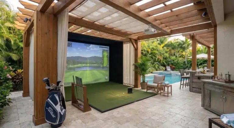 A premium outdoor golf simulator gazebo in Clearwater, Florida, featuring a weather-proof enclosure, integrated luxury wet bar with seating, wall-mounted television, and a professional-grade impact screen.