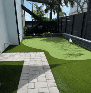 Sims & Greens | Coastal Performance Putting Green | St. Pete Beach, FL - Sims & Greens Professional outdoor putting green in St. Pete Beach, FL by Sims & Greens, featuring a multi-layered aggregate drainage sub-base, true-roll multi-directional turf, and a deep-cut chipping fringe.