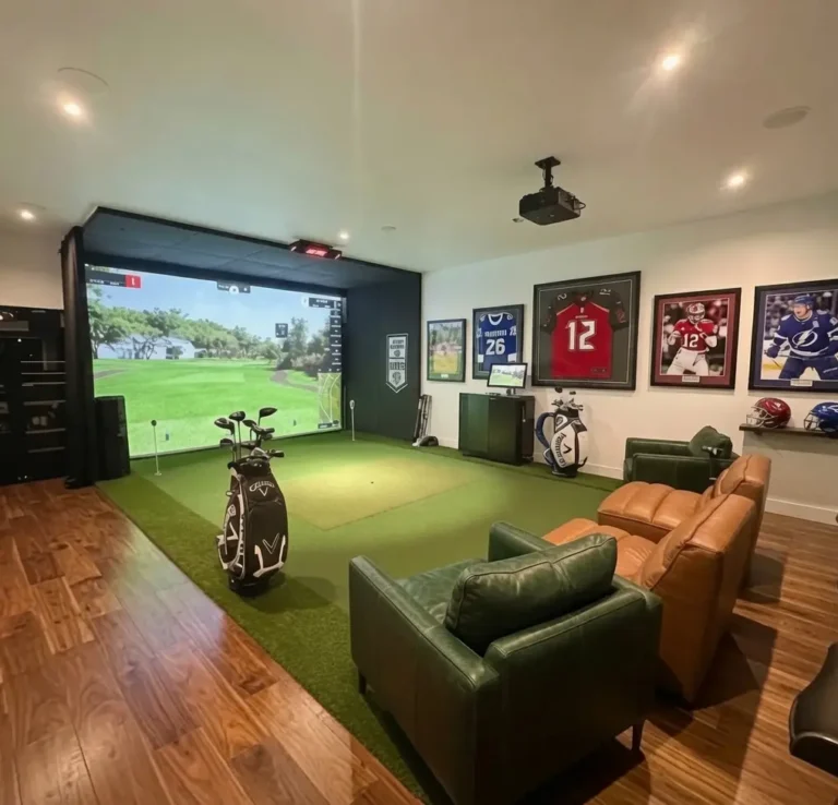 Luxury home man cave featuring a custom indoor golf simulator, premium putting turf, and lounge seating in Clearwater Florida.